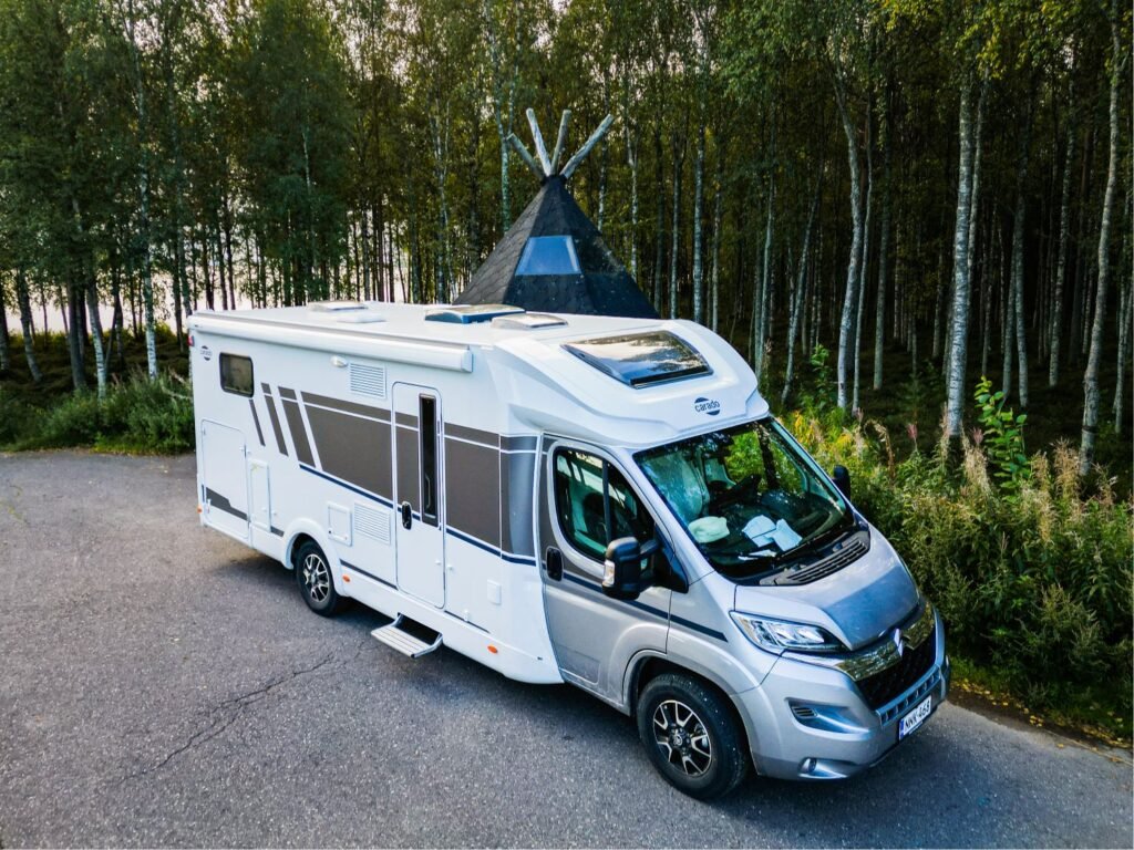 White and grey campervan in forest