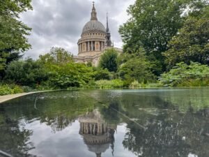 Large cathedral in background, reflection of cathedral in large pond