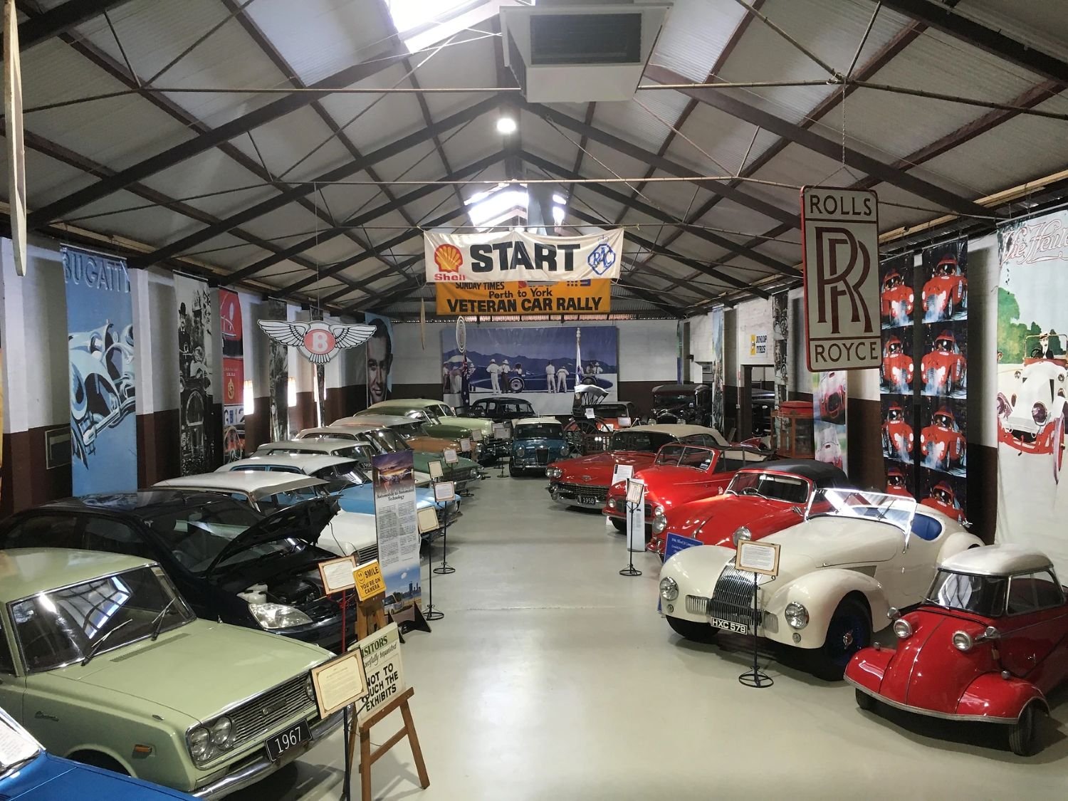Old cars lined up in museum indoors, York Motor Museum