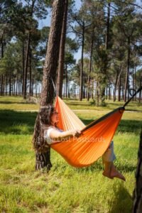 Nakie Hammock in pine forest, girl in hammock with white shirt, dark hair