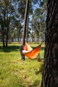 Nakie Hammock in pine forest, girl in hammock with white shirt, dark hair