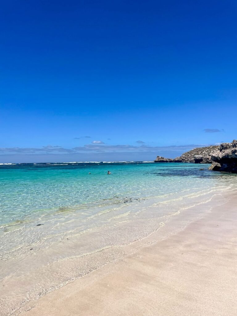 Crystal clear beach, White sand, rocky outcrop in distance, Rottnest Island