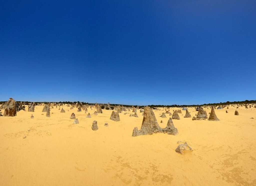 Large rock formations in yellow, sandy desert