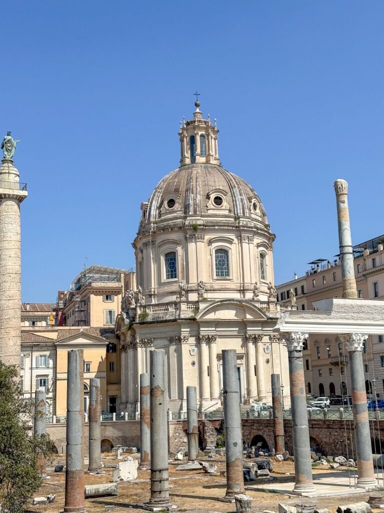 Large ruins of ancient forum, columns and cathedral in the background