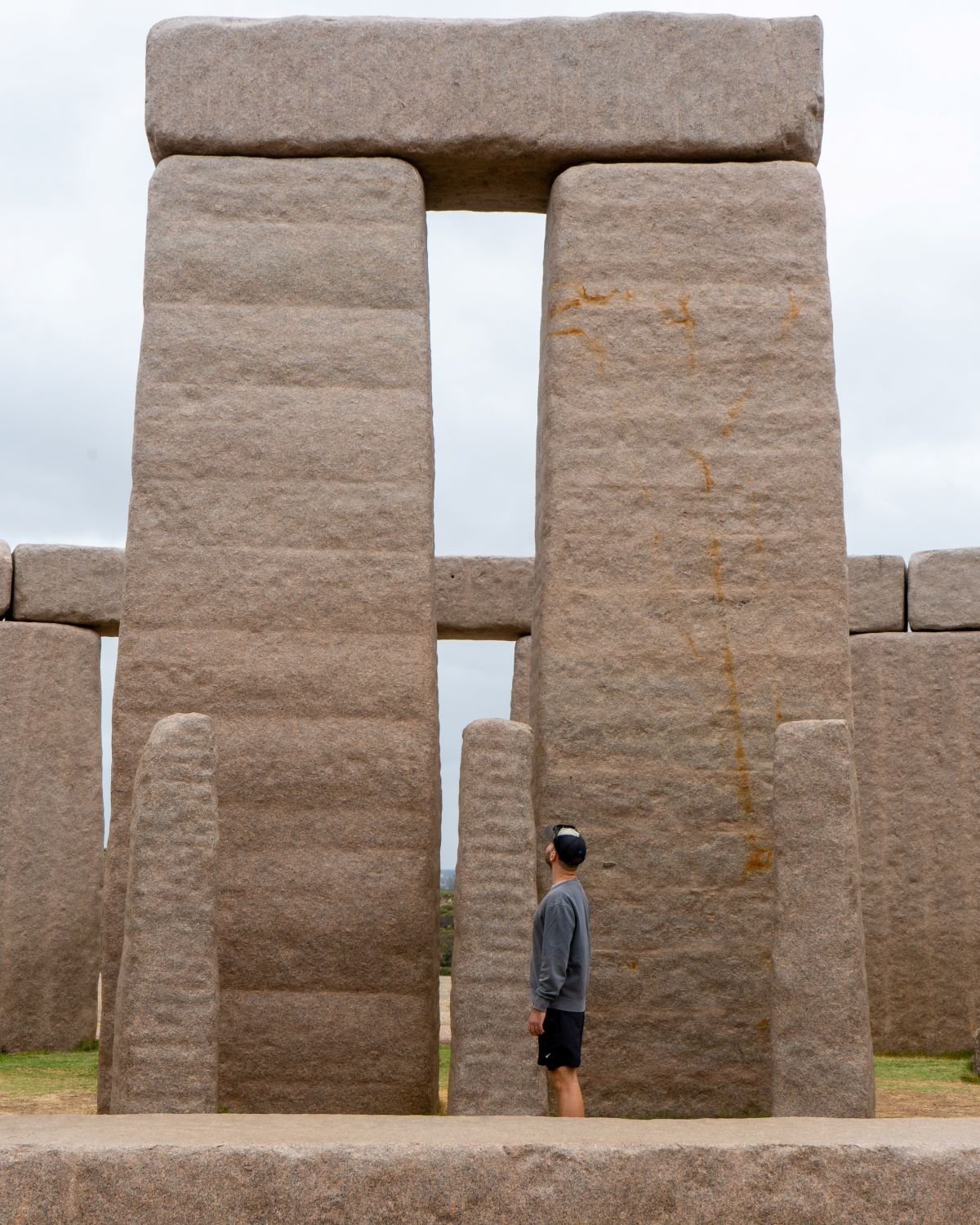 Person looking up at big granite rocks, Stonehenge, things to do in Esperance