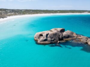 Twilight Beach Esperance, Bright blue beach with larage, rounded rock formation in the ocean
